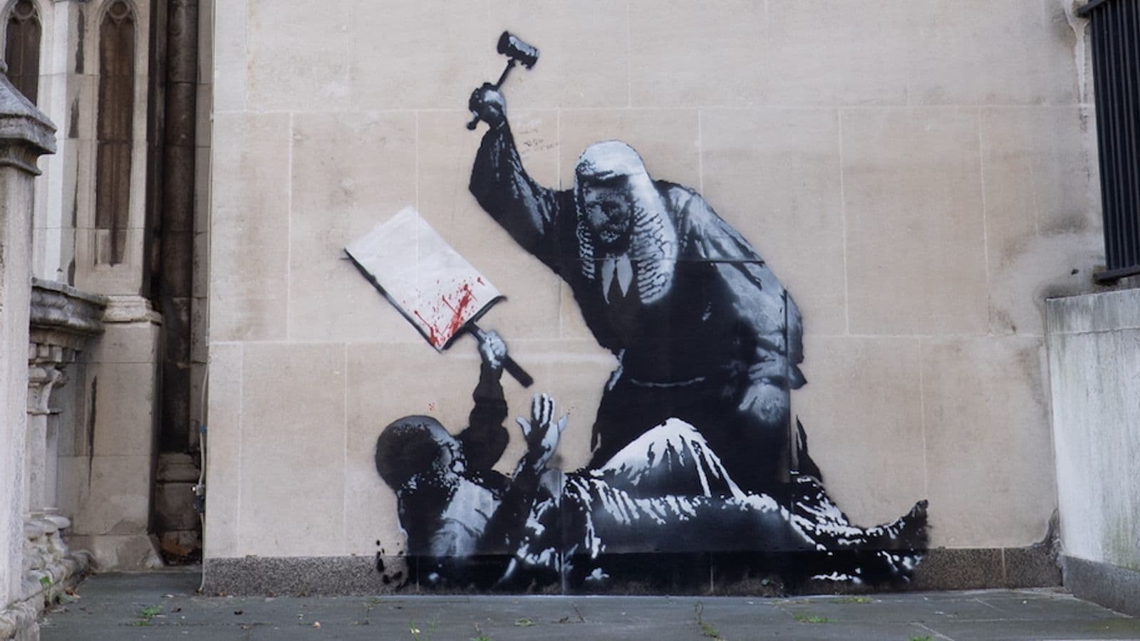 Banksy unveils new artwork outside the Royal Courts of Justice